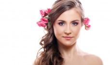 Beautiful woman with roses in hair
